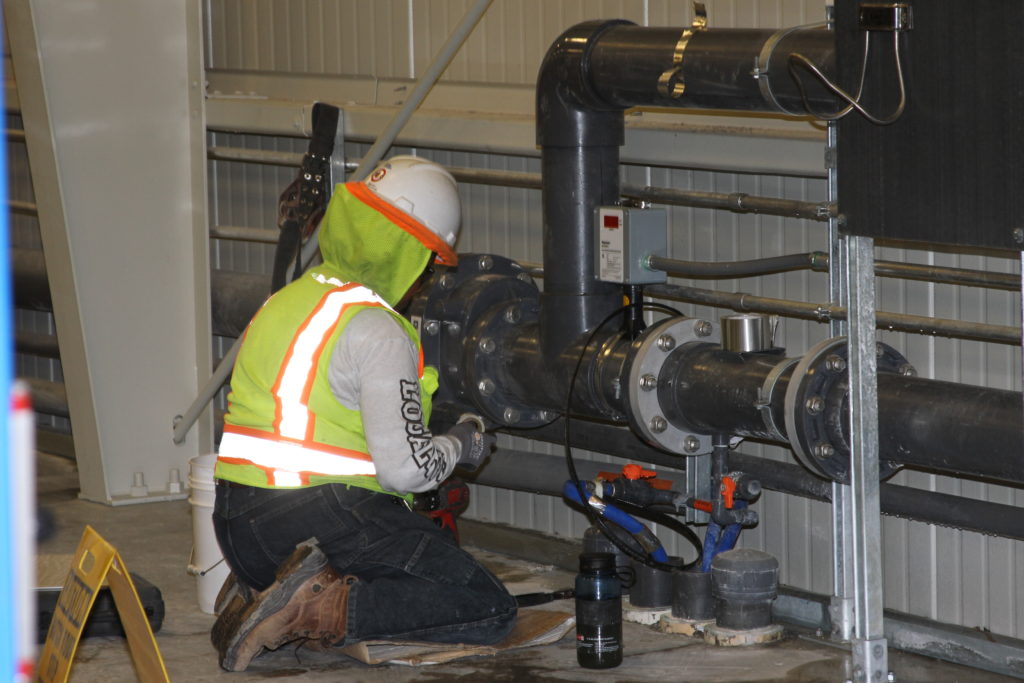 a man making repair on water pipe